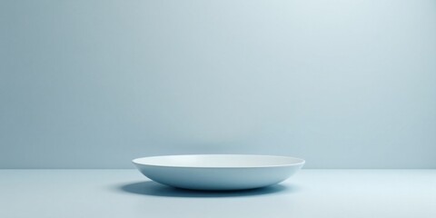 Poster - A Single, Empty, Pale Blue Bowl on a Light Blue Surface Against a Pastel Background