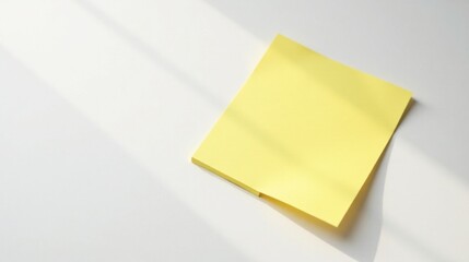 Aufkleber - A Single Pastel Yellow Note Pad Resting on a White Surface with Soft Light Shining Through a Window