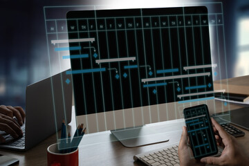 Poster - project management businessman using a cell phone and laptop to view a project plan