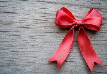 Canvas Print - Red ribbon bow on rustic gray wooden background. Perfect for holiday or gift giving designs. Simple elegant festive