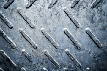 Poster - Textured metal surface with diamond pattern in close-up