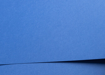 Poster - Deep sapphire blue paper background with a smooth texture and overlapping curved folds. Vibrant cobalt and ultramarine tones create a minimal, rhythmic, and flowing abstract composition with geometric