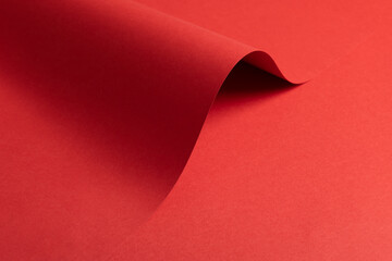 Poster - Fiery vermilion red paper background with a smooth texture and overlapping curved folds. Warm coral tones and wavy edges create a dynamic, flowing, and minimal abstract composition with subtle shadows