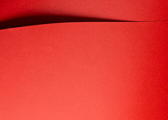 Poster - Fiery vermilion red paper background with a smooth texture and overlapping curved folds. Warm coral tones and dynamic geometric lines create a minimal, flowing abstract composition with subtle shadows