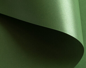 Leinwandbilder - Forest green paper background with a pearlescent, glossy texture and shimmering wavy edges. Rich basil and olive tones create an elegant, chic, and reflective abstract design.