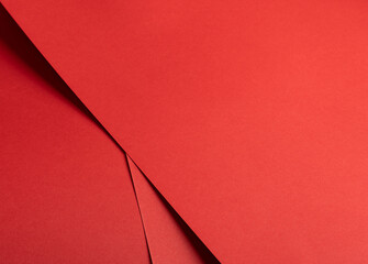 Poster - Fiery vermilion red paper background with a smooth texture and overlapping curved folds. Warm coral tones and dynamic geometric lines create a minimal, flowing abstract composition with subtle shadows