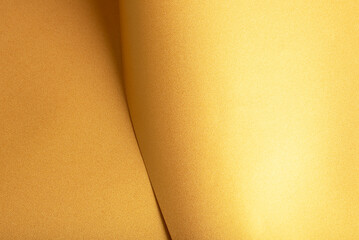 Leinwandbilder - Golden saffron paper background with a pearlescent, glossy texture and shimmering folds. Rich buttery tones and reflective highlights create an elegant, vibrant, and luxurious abstract design.