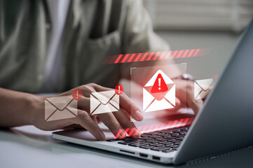 Fototapete - Spam email alert danger concept. person typing on laptop receives scam notification, illustrating cybersecurity risk and data breach threat in modern digital workspace.