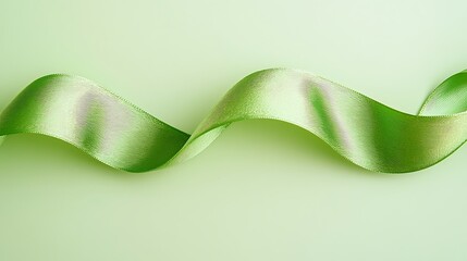 Canvas Print - Elegant light green satin ribbon swirls on pastel background.