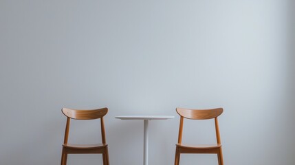 Poster - A Serene Scene of Two Empty Chairs Alone at a Minimalist Table Against a Soft Colored Wall