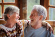 © simona - Portrait of elderly happy couple in indoor at home, mountain chalet, smiling and having fun together. Happiness and serene old lifestyle people enjoying vacation