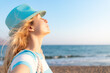 © Sunny studio - Young happy woman enjoying by sunrise against blue sea and sky on summer vacation