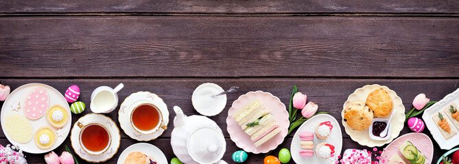 Aufkleber - Easter or spring tea bottom border against a dark wood banner background. Assortment of finger sandwiches, scones and sweet desserts. Top down view. Copy space.