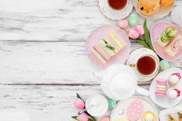 Aufkleber - Easter or spring tea side border against a white wood background. Selection of finger sandwiches, scones and sweet desserts. Top down view. Copy space.