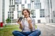 © Miljan Živković - man use mobile smart phone play video games sit outdoor