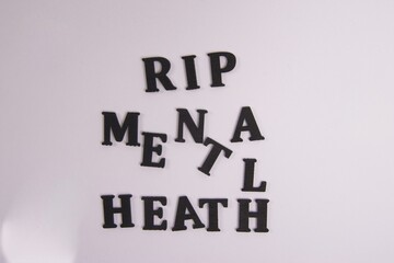 Wall Mural - RIP Mental Health Black wooden latter, white background, Moving forward, self-love, counseling, patient, positive thoughts 