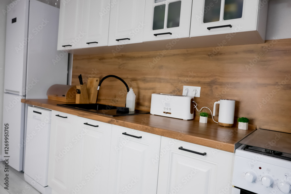 Counterop Side View Side view of the modern kitchen with white cabinet and wooden ...