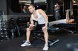 © JackF - Strong young man practicing with dumbbell in exercise room during weight training