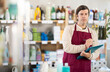 © JackF - Adult man seller with folder conducting inventory in household chemicals store