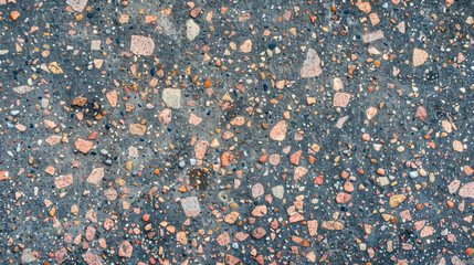 Poster - Textured concrete surface with colorful aggregate stones, creating unique pattern. blend of colors and shapes adds visual interest to material