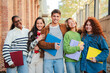 © Jose Calsina - Group of high school friends, standing together at university campus smiling and expressing pure delight and youthful friendship. Real teenage students looking at camera celebrating their bond