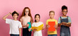 © Prostock-studio - Cool boys and girls with school textbooks and copybooks posing on pink background