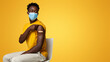 © Prostock-studio - Young Black Male In Medical Mask Showing Arm With Plaster After Vaccination, Vaccinated African American Man Demonstrating Shoulder With Adhesive Bandage, Got Covid-19 Vaccine Injection, Panorama