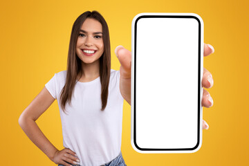 Aufkleber - Mobile App Advertisement. Excited Woman Showing White Empty Smartphone Screen Recommending App Posing Over Orange Studio Background, Smiling To Camera. Check This Out, Cellphone Display Mock Up