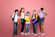 © Prostock-studio - Education during virus pandemic concept. Full length portrait of schoolkids in medical masks waving on pink background