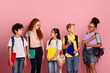 © Prostock-studio - Cute schoolkids of different races and ages looking at each other over pick background