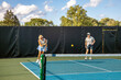 © pics721 - Female Pickleball Player Returning Serve