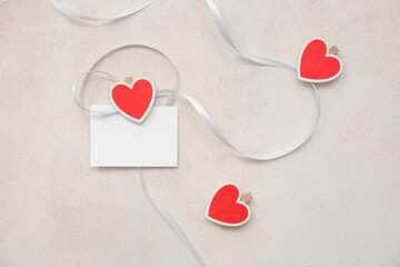 Wall Mural - Blank postcard with ribbon and hearts on white grunge background. Valentine's Day celebration