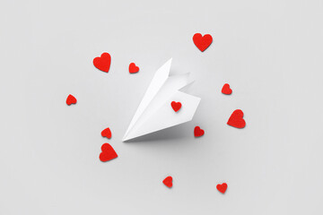 Wall Mural - Paper airplane with red hearts on white background. Valentine's Day celebration