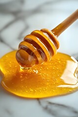 Poster - Golden Honey Dripping from Wooden Dipper on Marble Surface in Bright Studio Light Still Life