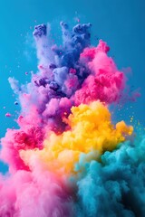 Poster - Vibrant Cloud of Colorful Powder Explosion Against a Clear Blue Sky Background Abstract Art