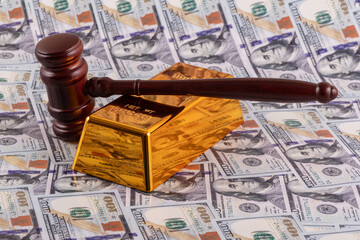 Wall Mural - 
Gold bar and judge's gavel against a background of US $100 bills