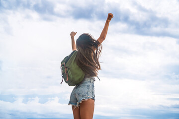 Wall Mural - happy tourist woman with backpack enjoying freedom and travel. wellbeing, journey and tourism concep