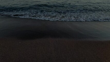 Wall Mural - waves crashing against the seashore at night