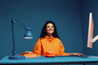 © Jacob Lund - Confident young female creative smiling and sitting at desk in studio shot