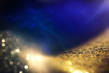 Wall Mural - abstract glitter blue and gold lights background. de-focused