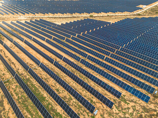 Aerial shot of photovoltaic panels in Teruel, Spain, arranged in structured rows. Clean energy generation supporting climate change solutions.
