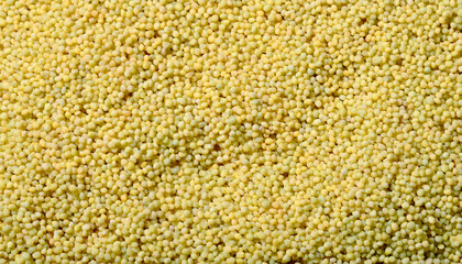 Fototapete - Repeating pattern of tiny couscous grains, emphasizing their uniform size and golden color. Ideal for Mediterranean cuisine or healthy food concepts. Texture, background.
