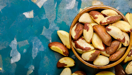 Fototapete - Background featuring Brazil nuts texture, showcasing their rough surface and earthy tones. Ideal for healthy snacks, baking, or natural food concepts. Texture, background.