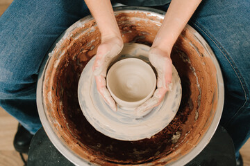 Poster - Potter creates a ceramic bowl in the pottery studio. Process of making a unique ceramic shape.