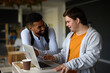 © Halfpoint - Happy young man with Down syndrome and his tutor using lapotp indoors at school.