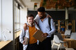 © Halfpoint - Young man with Down syndrome and his buddy with arms around his shoulders, walking down the school hallway.