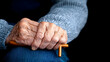 © bcendet - Elderly person's hand resting on a cane, symbolizing aging and fragility