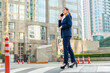 © StockPhotoRepublic - Confident Asian Businesswoman in Blue Suit Talking on Phone in City