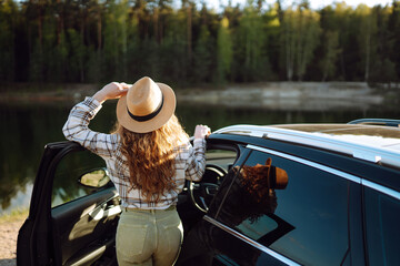 Wall Mural - Young woman  enjoys the view nature during car travel.  Europe travel. Lifestyle, vacation, tourism, nature