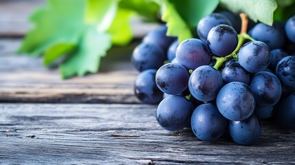 Poster - Fresh ripe black grapes with vibrant green leaves on a rustic wooden table for healthy eating and wine making : Generative AI